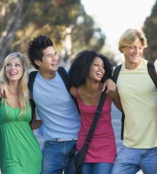 Teens standing in group with arms around each other
