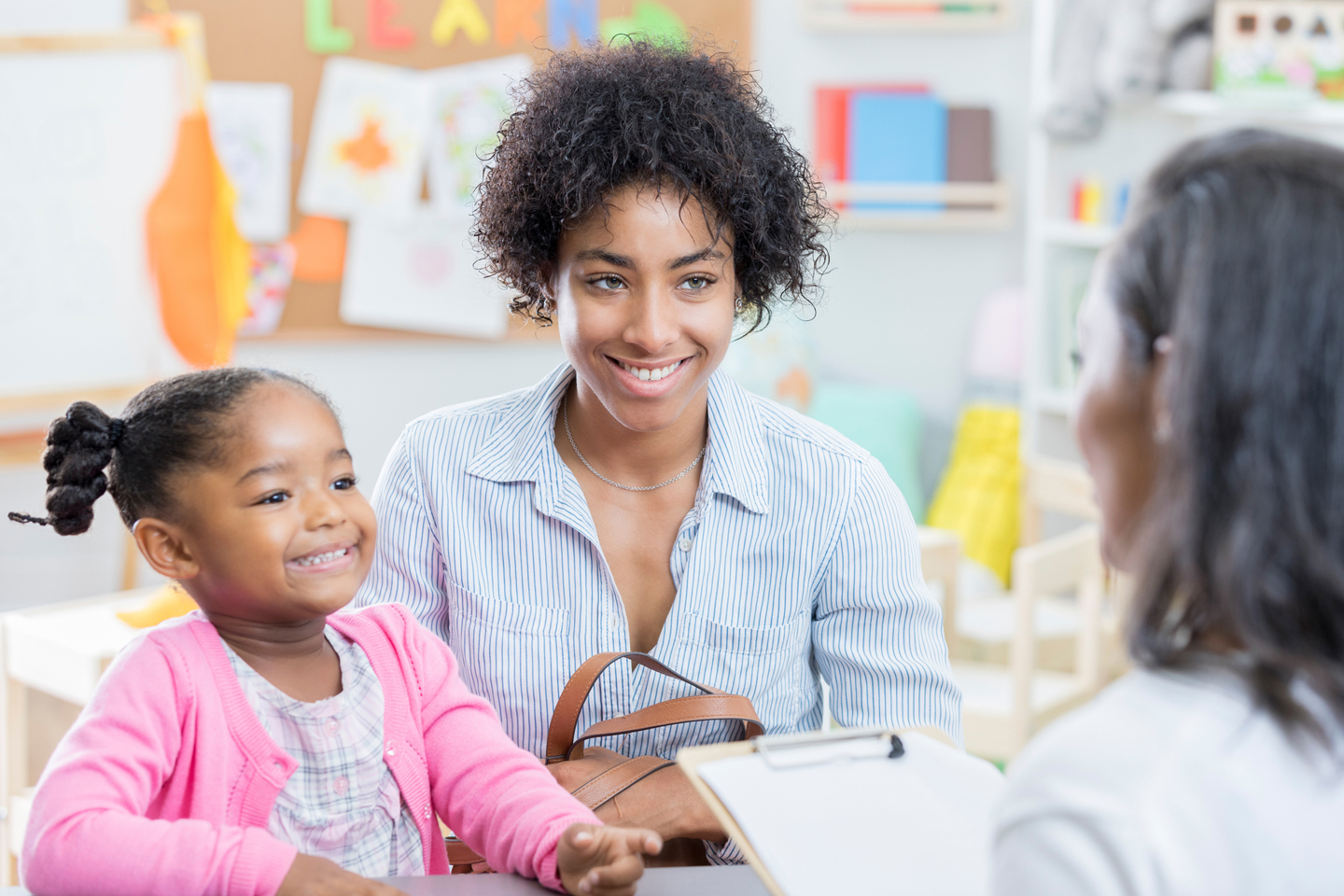 Parent and child meeting with teacher