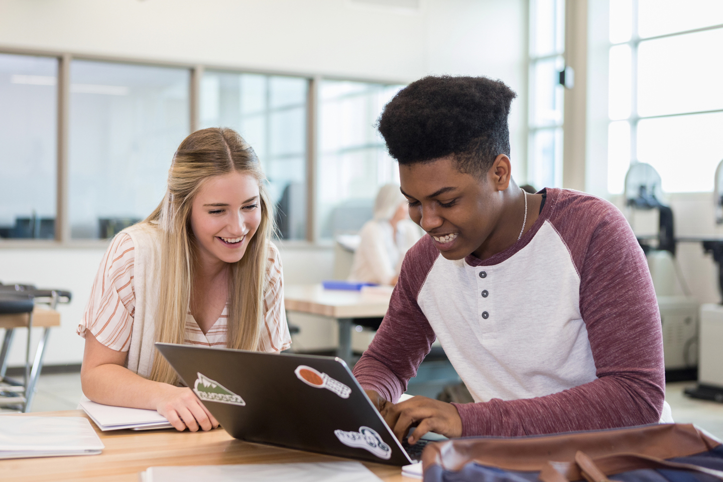 Students looking at laptop