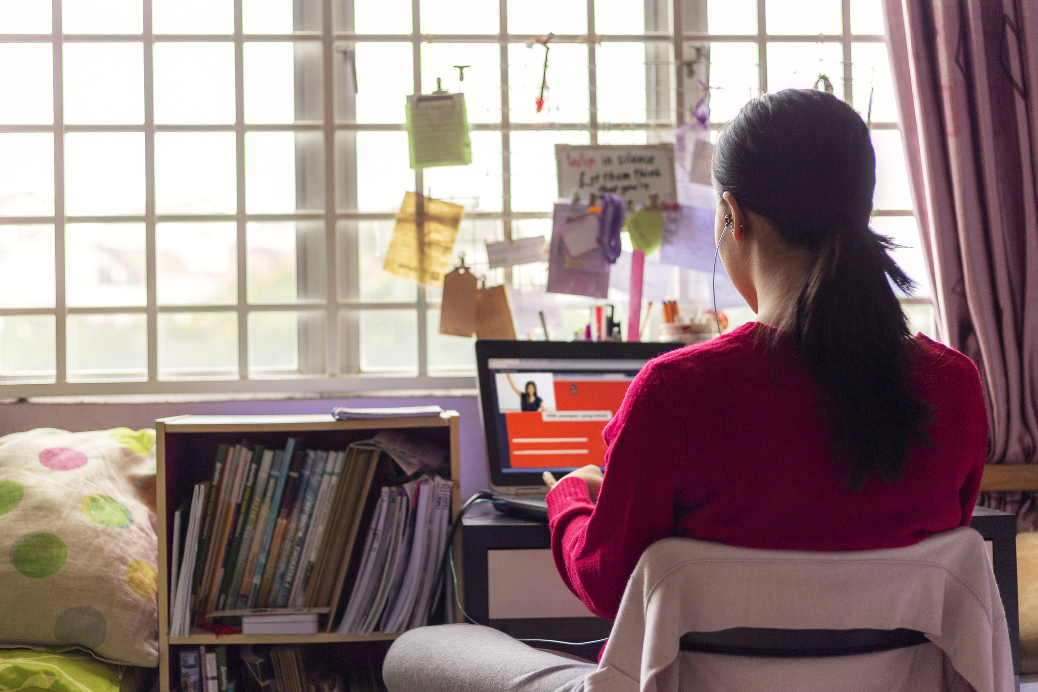 Secondary student sitting at a laptop