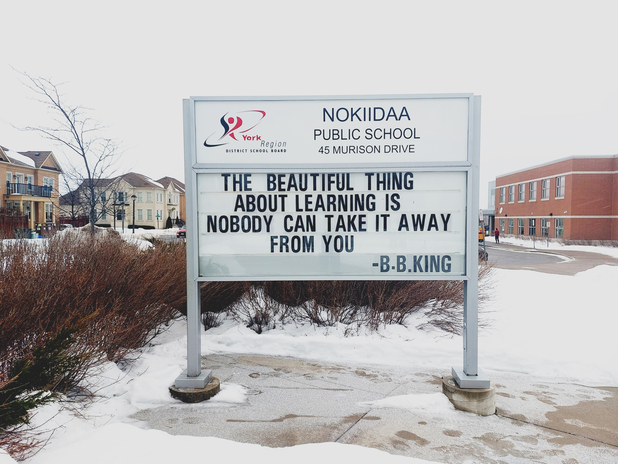 School sign reading Nokiidaa Public School, and BB King quote "The beautiful think about learning is nobody can take it away from you."