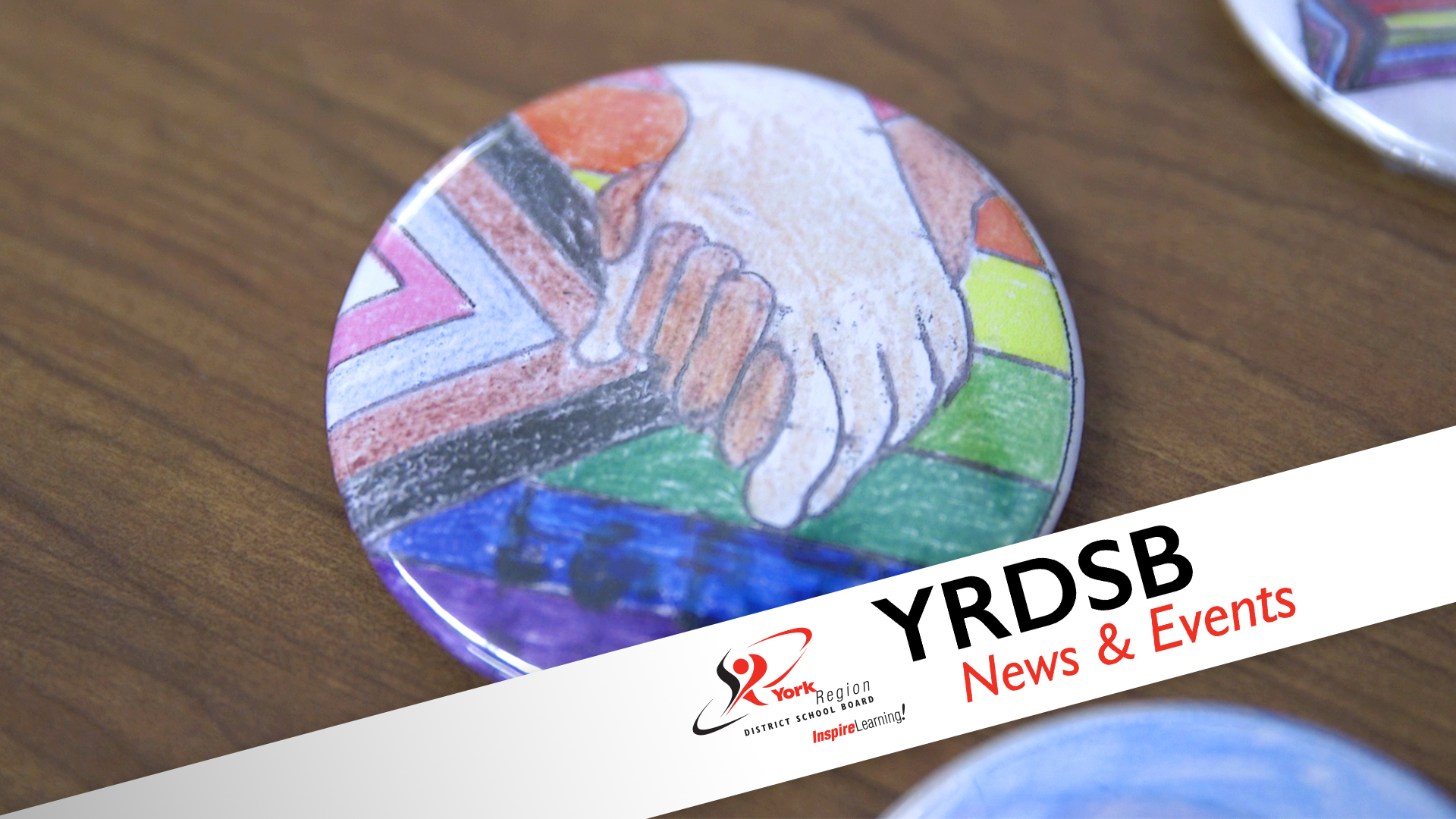 Positive spaces button - image of pride flag with hands holding