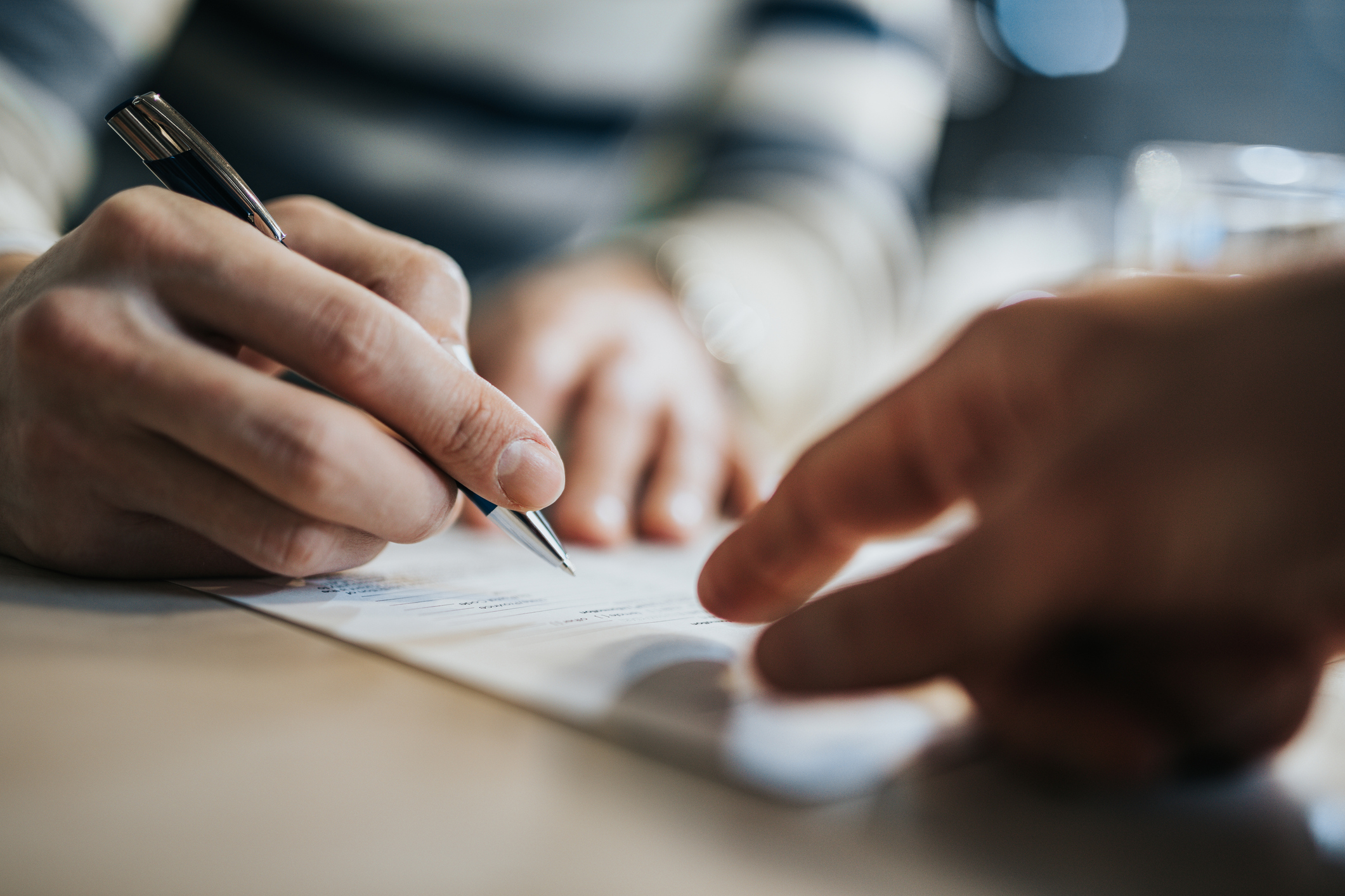 photo of hands over paper