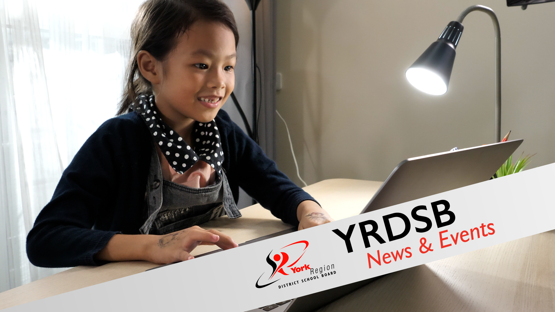 Student working at desk on laptop
