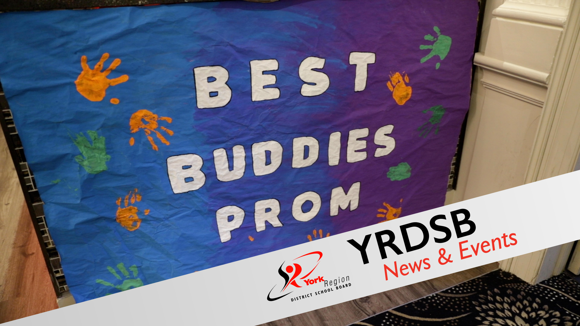Blue background covered in orange and green handprints reads Best Buddies Prom