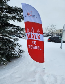 Flag in snow reads Walk to School