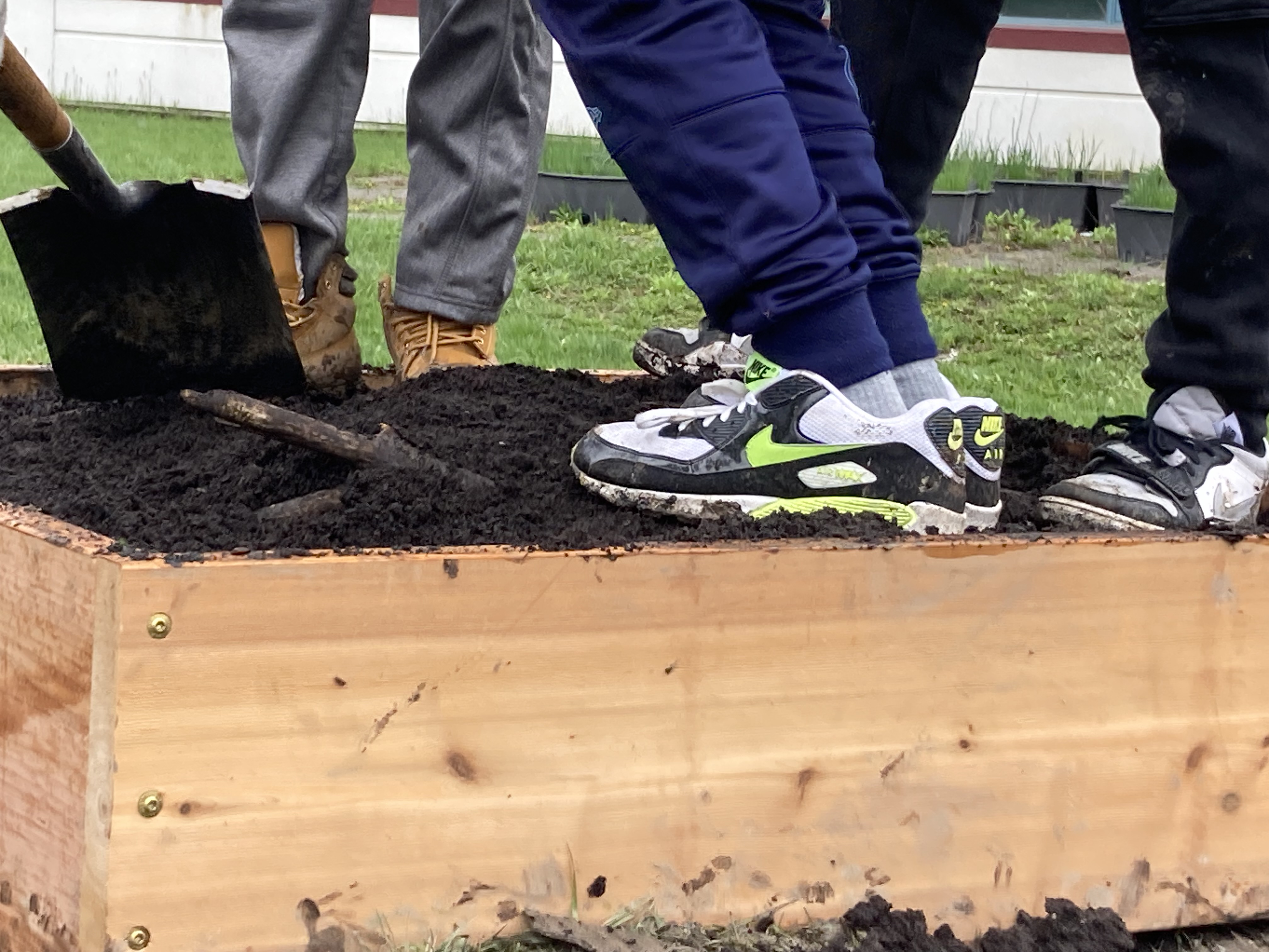 shoes on soil with shovel
