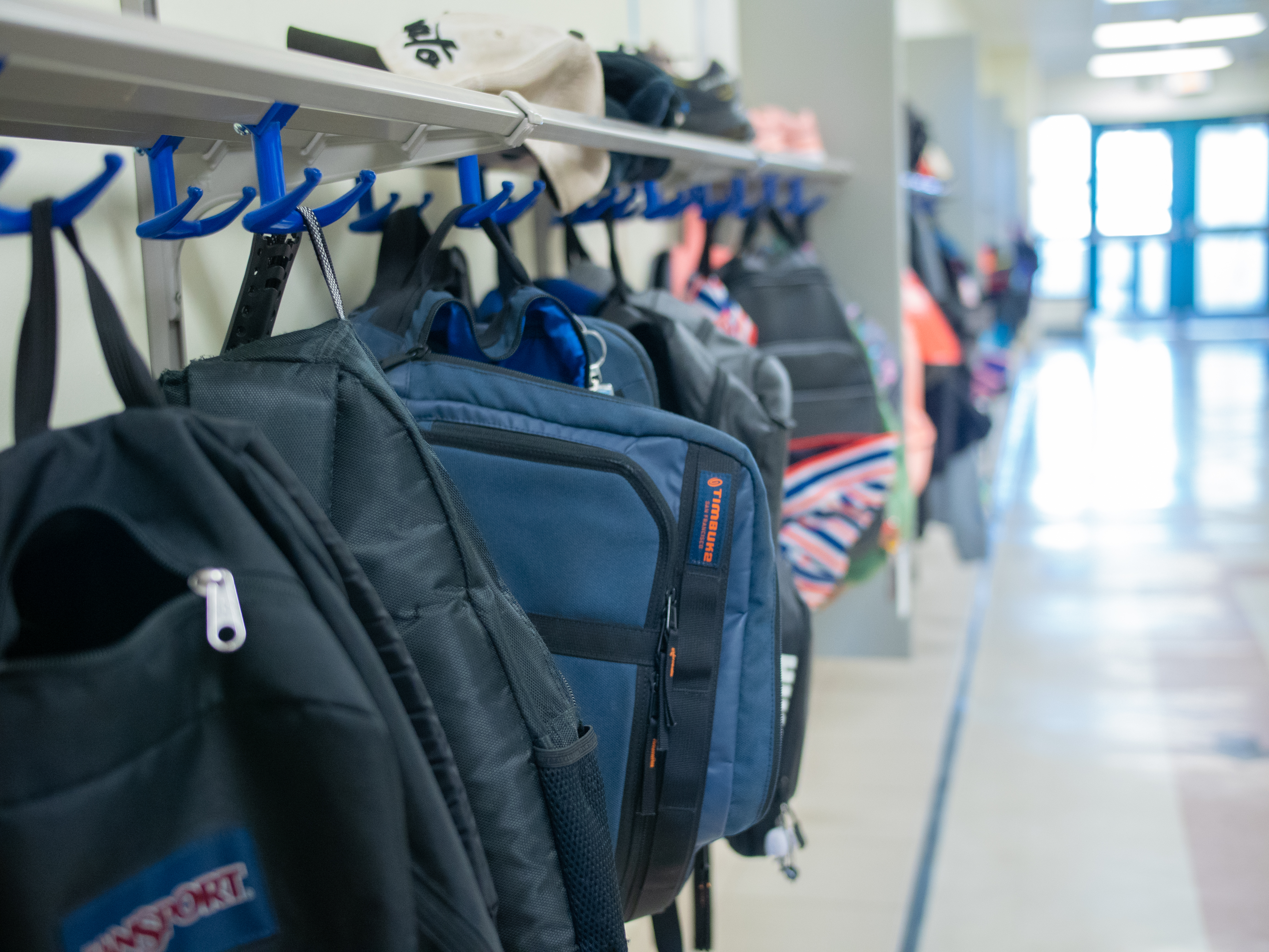 backpacks in school hallway