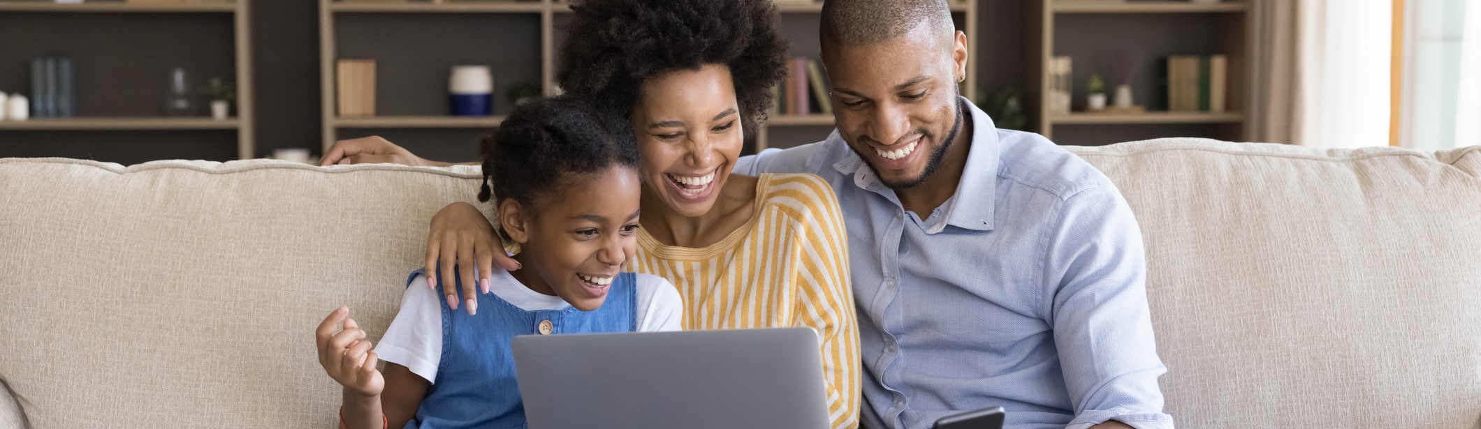 black family using laptop and mobile device
