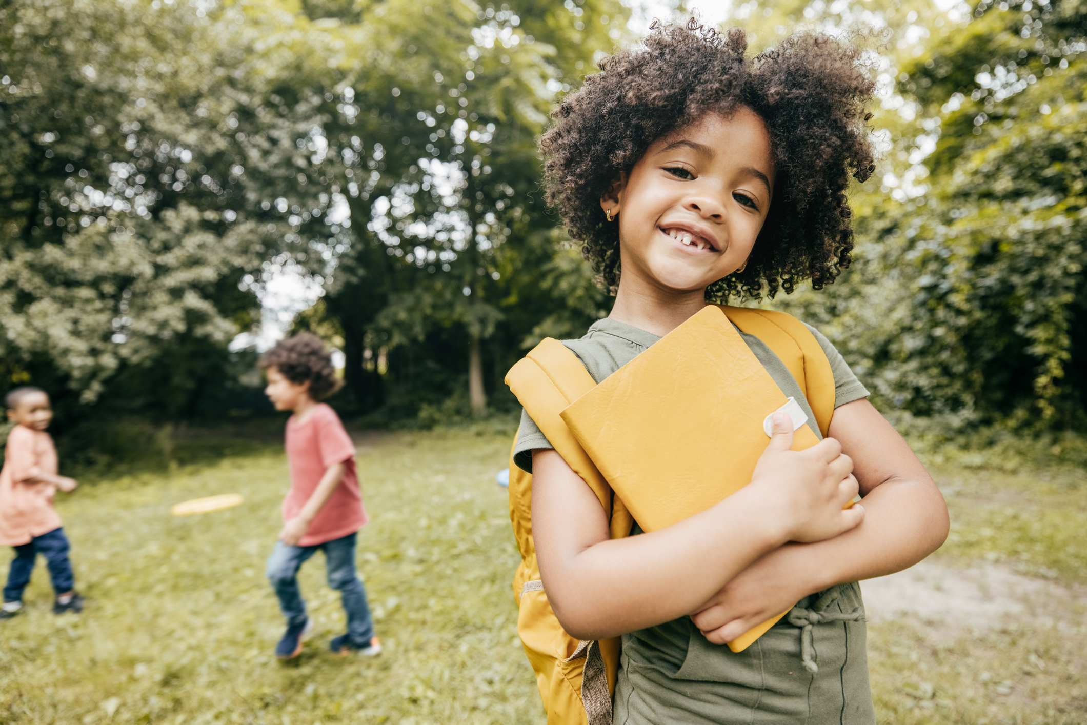student holding notebook outdoors