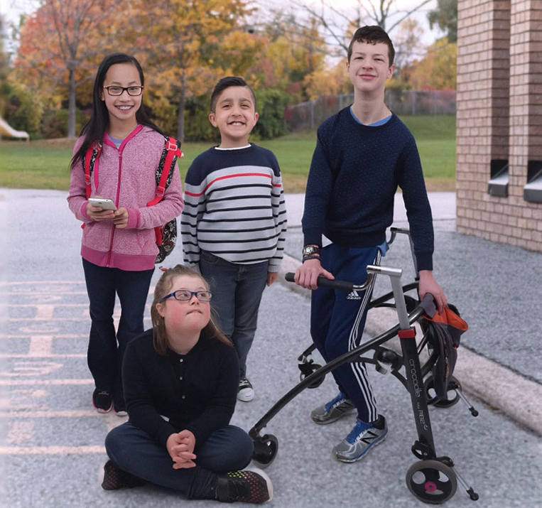 group of students standing beside a school