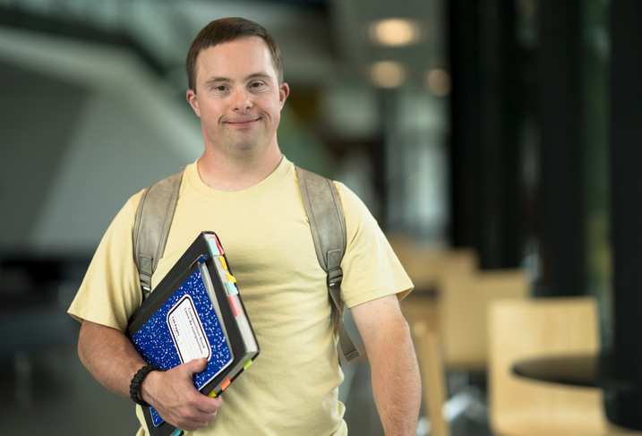 Secondary student standing in a school building