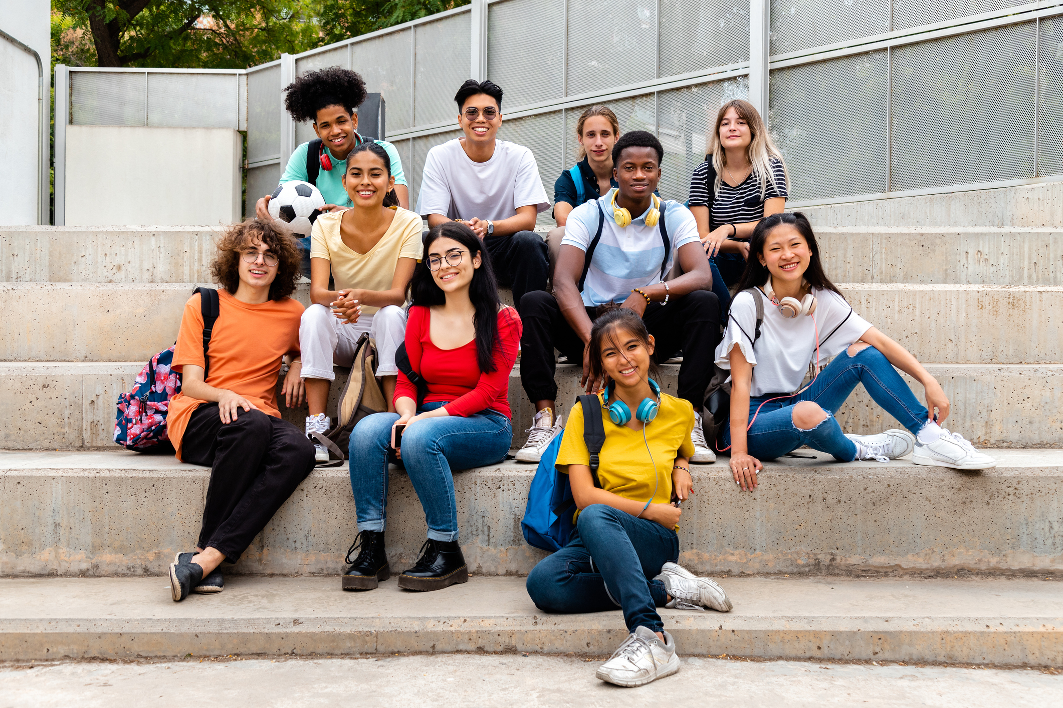 secondary students sitting on stairs