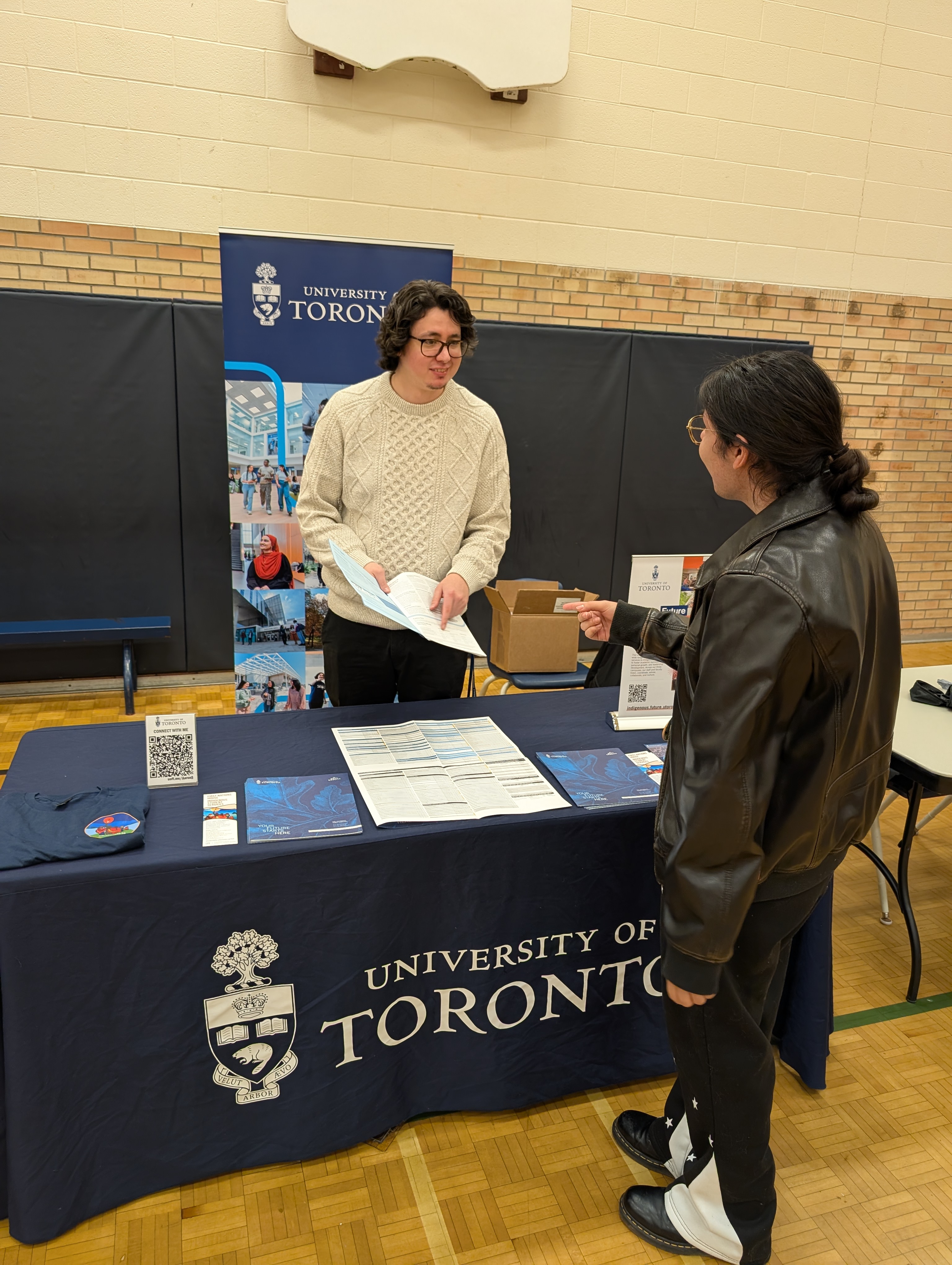 student speaking with university recruiter