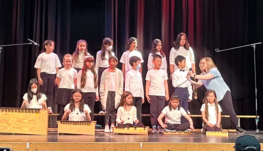 choir of students sings on a stage