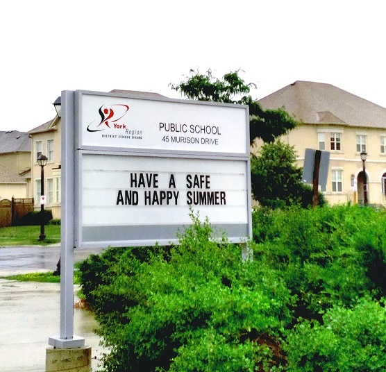 School sign with name of school removed. Now reads "public school"