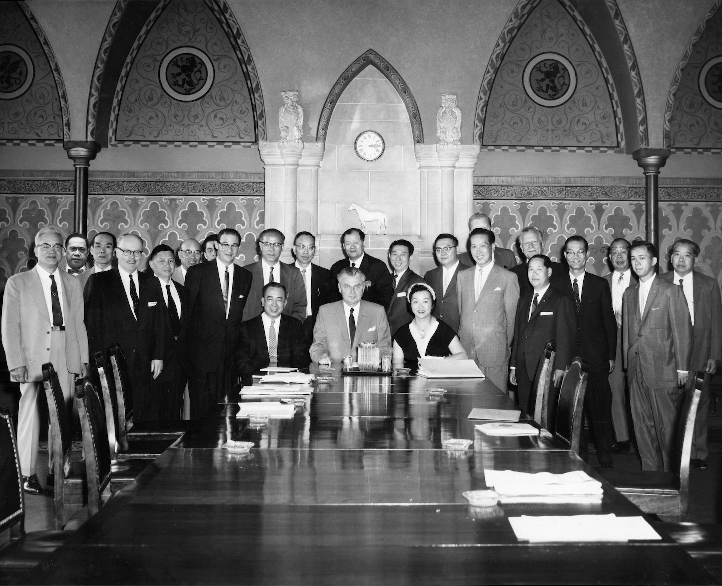 black and white photograph of people gathered around table