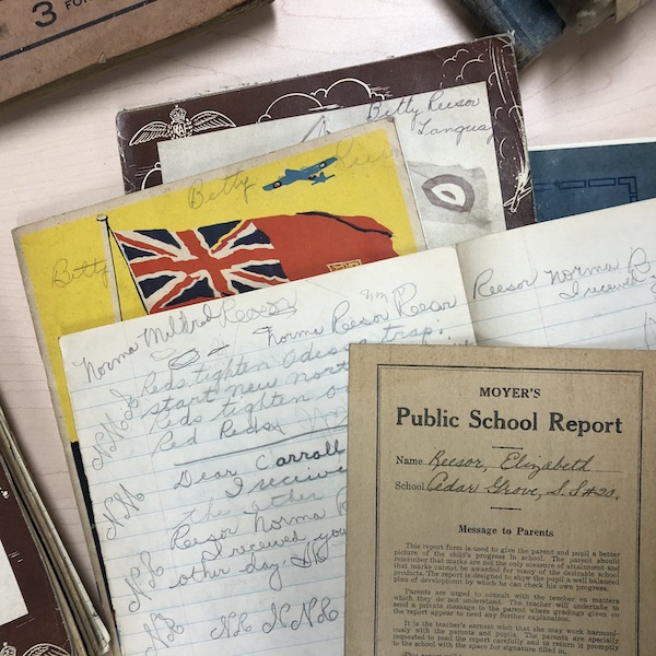 A collection of school notebooks and school reports