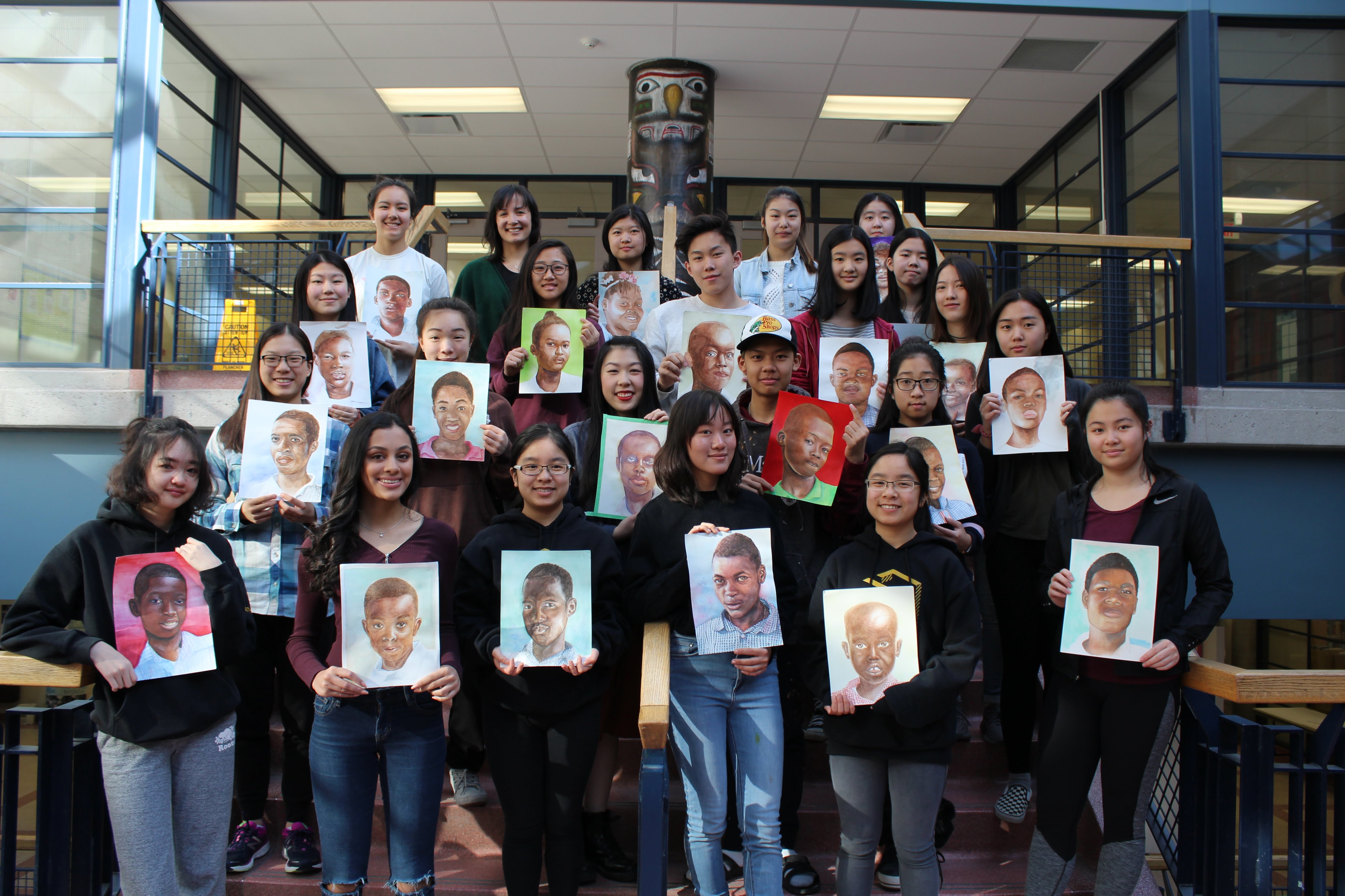 Students with the portraits they created