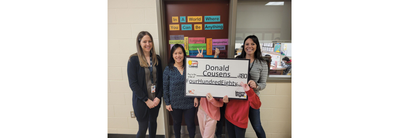 Learnstyle representatives and teacher at Donald Cousens pose with large grant cheque.