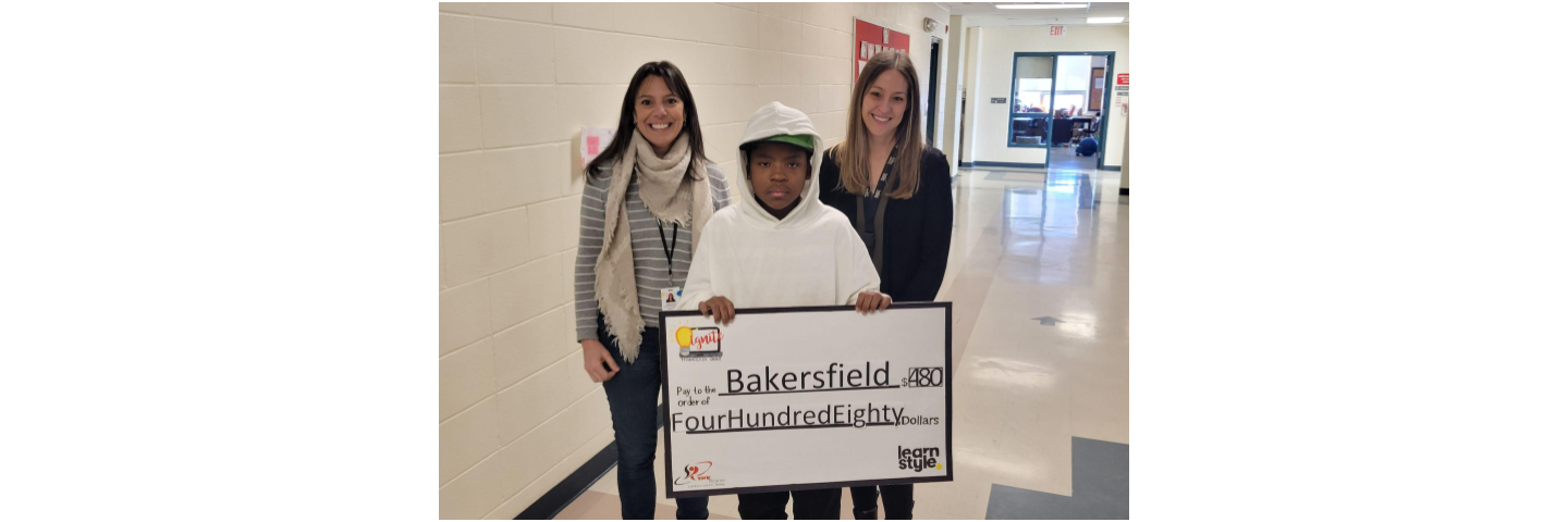 Student from Bakersfield holding the large grant cheque with representatives from learnstyle.