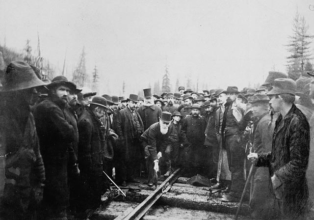 men in circle around railway lines