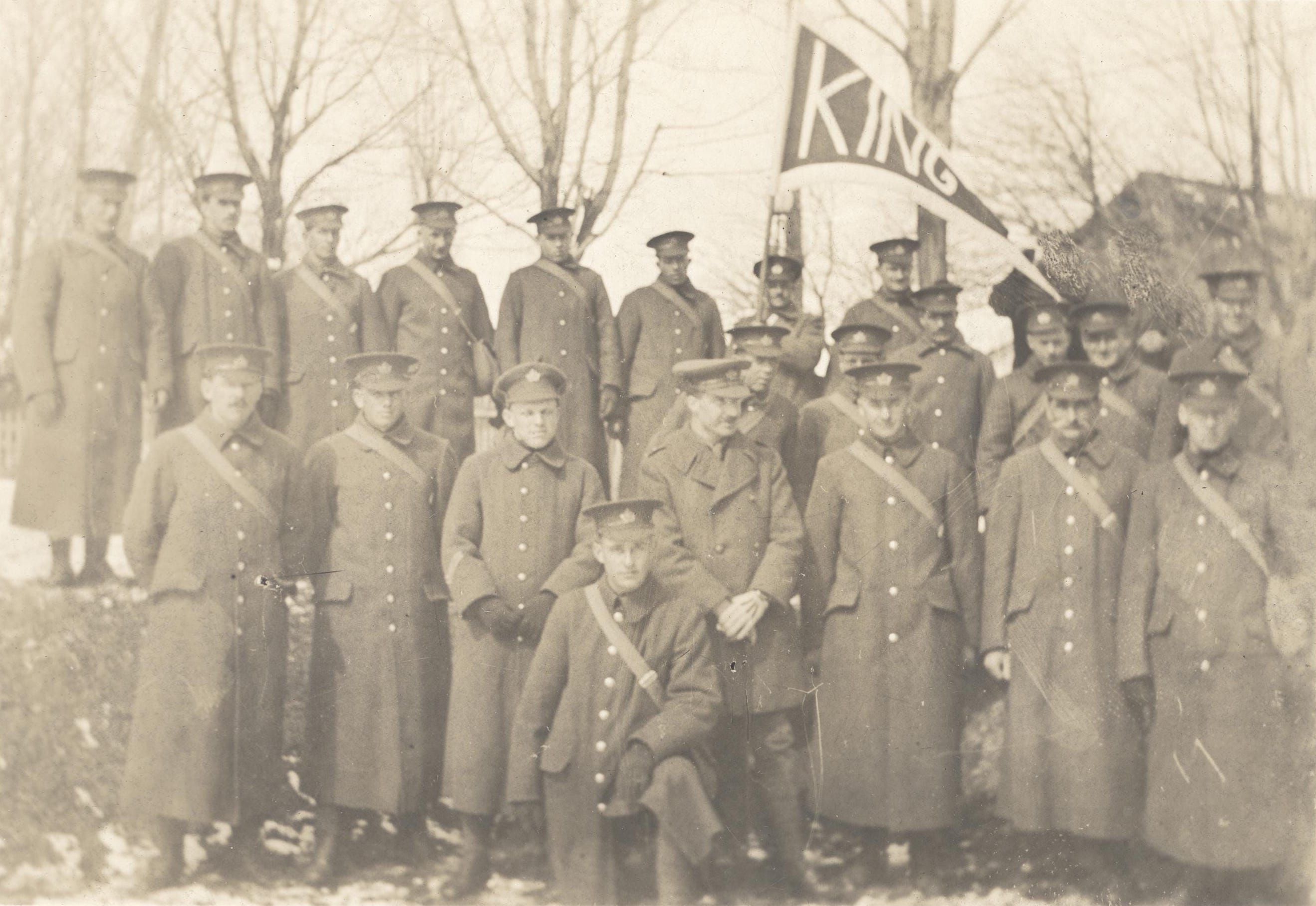 Black and white photograph of soldiers with King Township banner