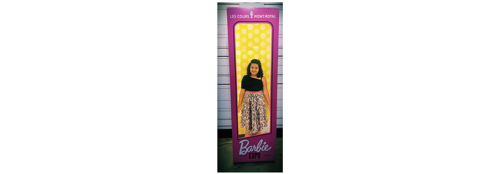 Student IG standing in a barbie box at barbie expo