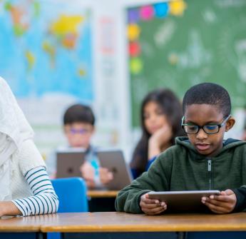 Students working on technology in classroom