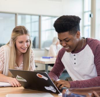 Students looking at laptop