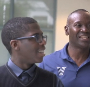 student and teacher walking and smiling