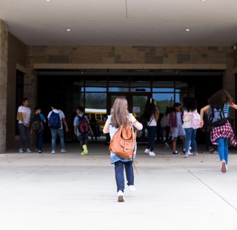 Students walking up to school building