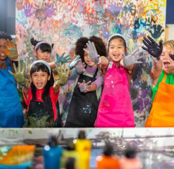 elementary students paint on hands art class