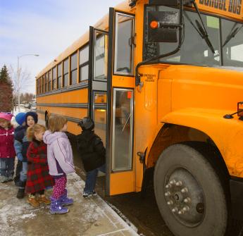 elementary students walking to bus winter