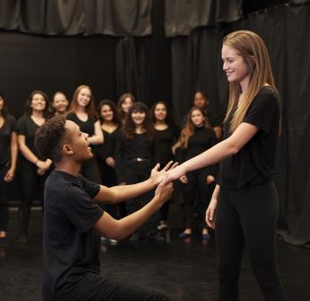 secondary students performing on stage drama