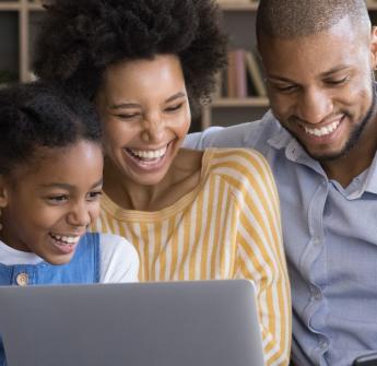 black family using laptop and mobile device