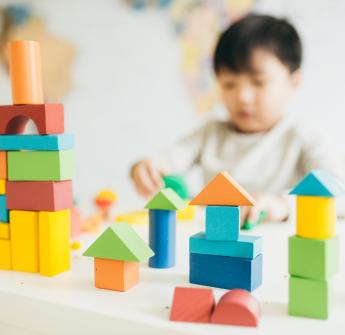 elementary student playing with blocks