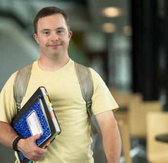 Secondary student standing in a school building