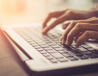 Hands Typing on Keyboard
