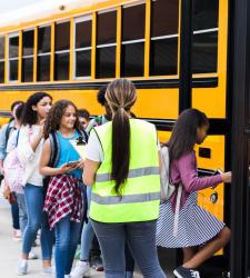 Elementary students getting on bus