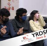 Three students sitting on couch wearing masks