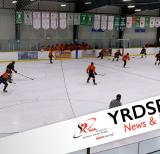 Hockey players playing ice hockey in indoor arena