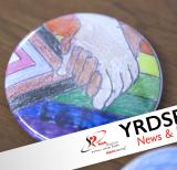 Positive spaces button - image of pride flag with hands holding