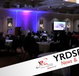 Large room with students seated at tables
