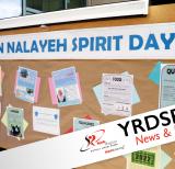Bulletin board that reads Hodan Nalayeh Sprit Day with papers posted on it