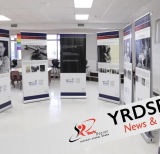 semi-circle of stand-up banners displaying information about the holocaust