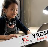 Student working at desk on laptop