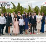 Student award recipients standing outside in a group with a backdrop of tall shrubs. Their names are listed beneath the photo.