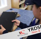 Student holding laptop