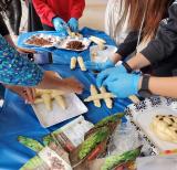 Hands fold dough on a table